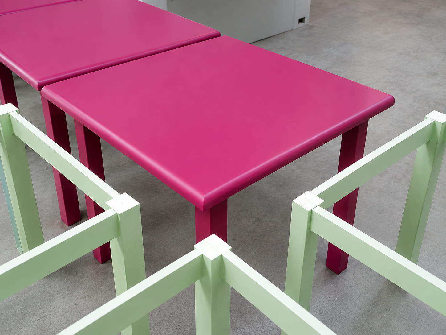Brightly painted children's tables and stools in the workshop