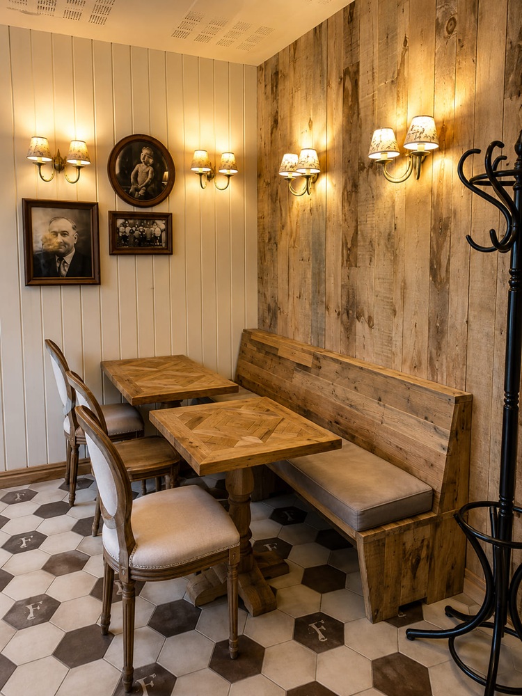 Banchetă de colț de restaurant din lemn recuperat, cu mese cu blat de parchet și scaune cu spătar fusiform